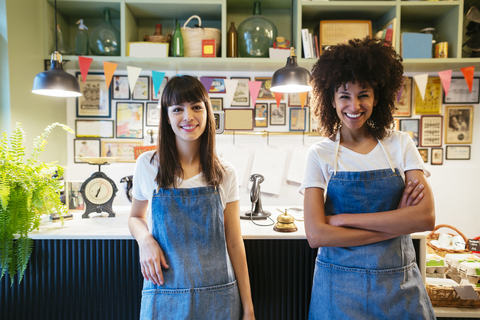 Portrait of two smiling women in a store stock photo