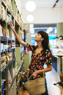 Customer looking for product at shelf in a store - EBSF02257