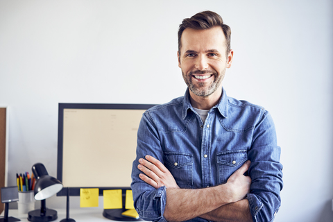 Portrait of smiling man in office stock photo