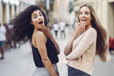 Portrait of two astonished young women on the street - JSMF00046