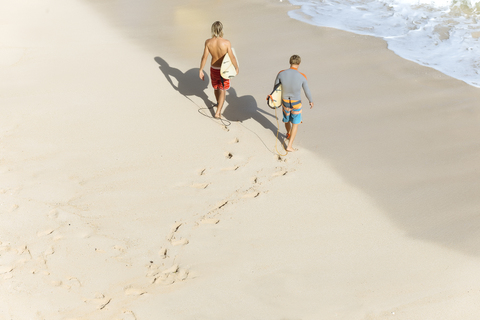 Indonesia, Bali, Surfers walking aat Bingin beach stock photo