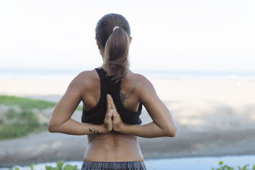 Indonesia, Bali, woman stretching arms - KNTF01077