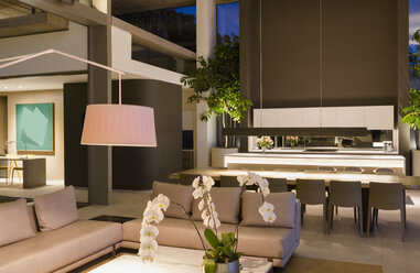 Illuminated modern, luxury home showcase interior living room and kitchen - HOXF01088