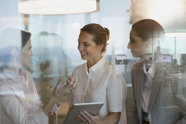 Businesswomen with digital tablet working in office - HOXF01205