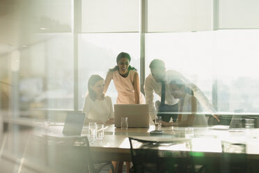 Business people working at laptop in conference room meeting - HOXF01246