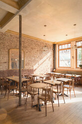 Wood tables and chairs in empty cafe - HOXF01481