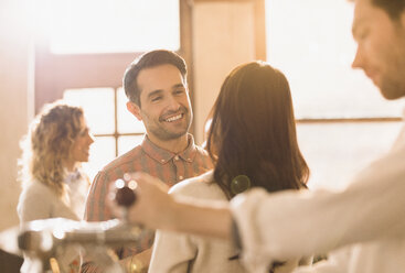 Smiling man talking to woman in bar - HOXF01513