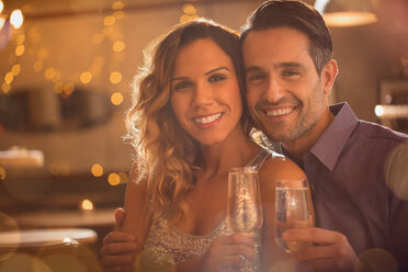 Portrait smiling couple drinking champagne - HOXF01540