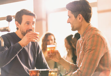 Men friends sampling beer at microbrewery bar - HOXF01565