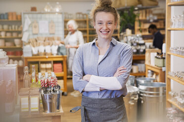 Portrait smiling female business owner working in shop - HOXF01804