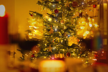 Illuminated Christmas tree with ornaments and string lights - HOXF01934