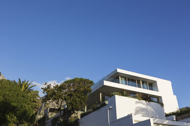 Modern luxury white home showcase exterior under blue sky - HOXF02000