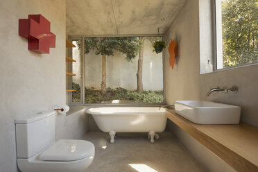 Modern, minimalist luxury bathroom with soaking tub and windows - HOXF02030