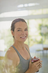 Portrait smiling woman drinking juice smoothie - HOXF02041