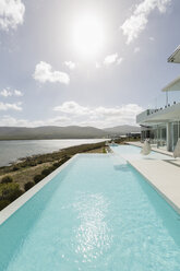 Sunny tranquil home showcase exterior infinity pool with ocean view - HOXF02124