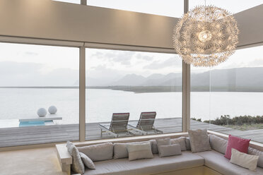 Modern luxury home showcase interior living room with chandelier and ocean view - HOXF02155