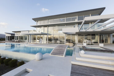 Tranquil modern luxury home showcase exterior with swimming pool and footbridge - HOXF02162