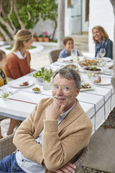 Portrait smiling senior man enjoying patio lunch - HOXF02251