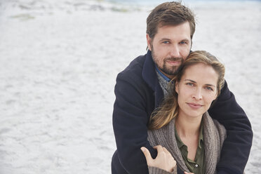 Portrait serene affectionate couple hugging on beach - HOXF02275