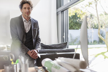 Portrait confident male architect in home office - HOXF02284