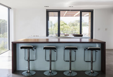 Simple, modern home showcase interior kitchen island with barstools - HOXF02312