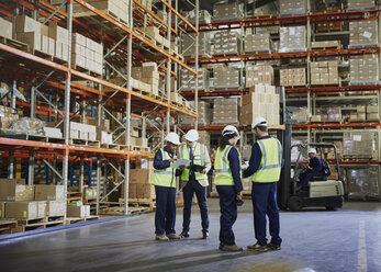 Workers meeting and talking in distribution warehouse - HOXF02452