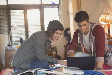 Junge Männer, die an einem Laptop studieren - HOXF02563