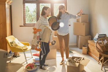 Mother helping young adult daughter moving into new apartment - HOXF02570