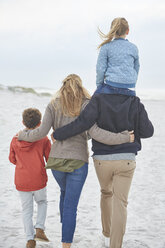 Family walking on winter beach - HOXF02647