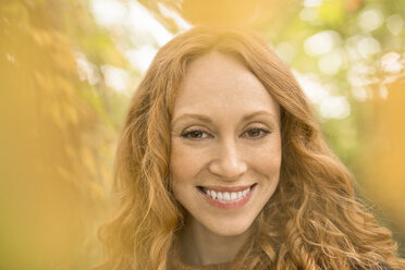 Close up portrait smiling woman with red hair - HOXF02700