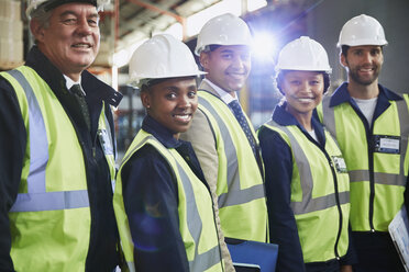 Portrait confident managers and workers in distribution warehouse - HOXF02838