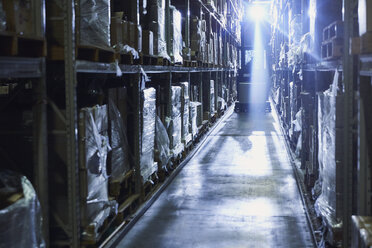 Back lit forklift in distribution warehouse aisle - HOXF02864