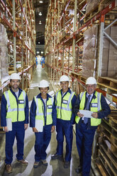 Portrait smiling workers in distribution warehouse - HOXF02896