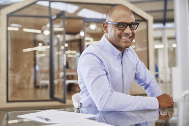 Portrait smiling businessman in office - HOXF03008