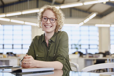 Portrait smiling businesswoman in office - HOXF03015