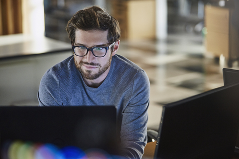 Businessman working at computer in office stock photo