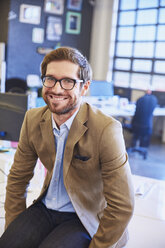 Portrait smiling businessman in office - HOXF03084