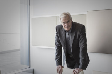 Portrait confident senior businessman in conference room - HOXF03239