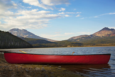 Red boat moored at lakeshore against mountains - CAVF00019