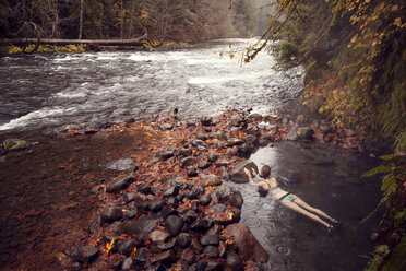 High angle view of woman swimming in hot spring at forest - CAVF00070