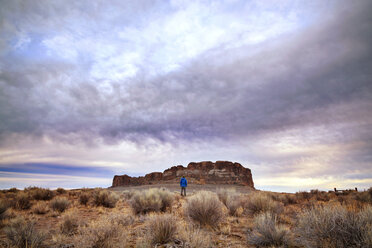 Man standing on field against cloudy sky - CAVF00124