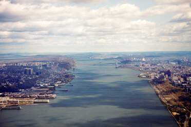 Scenic view of river amidst city against cloudy sky - CAVF00299