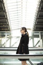 Businesswoman with suitcase walking at railroad station - CAVF00433