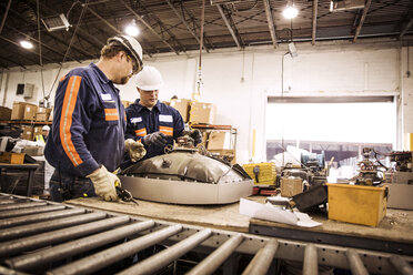 Male workers checking electrical equipments in recycling plant - CAVF00527