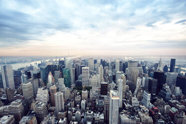 Aerial view of modern cityscape against cloudy sky - CAVF00632