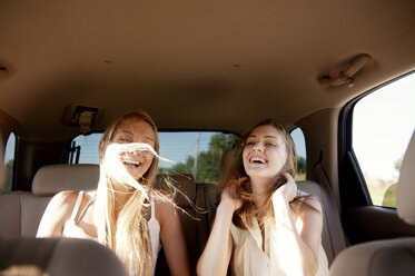 Happy friends traveling in car - CAVF00890