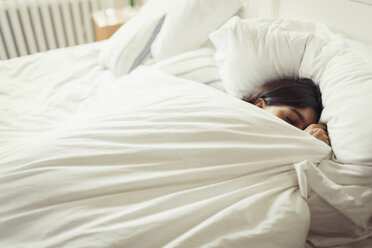 Tired young woman sleeping in bed - CAIF04618