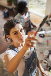 Young woman painting wall - CAIF04682