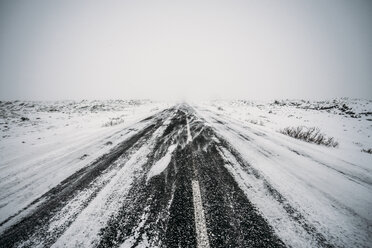 Diminishing perspective remote snow covered road - CAIF04742