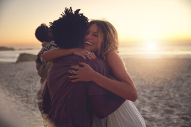 Affectionate couple hugging on sunny sunset summer beach - CAIF04836